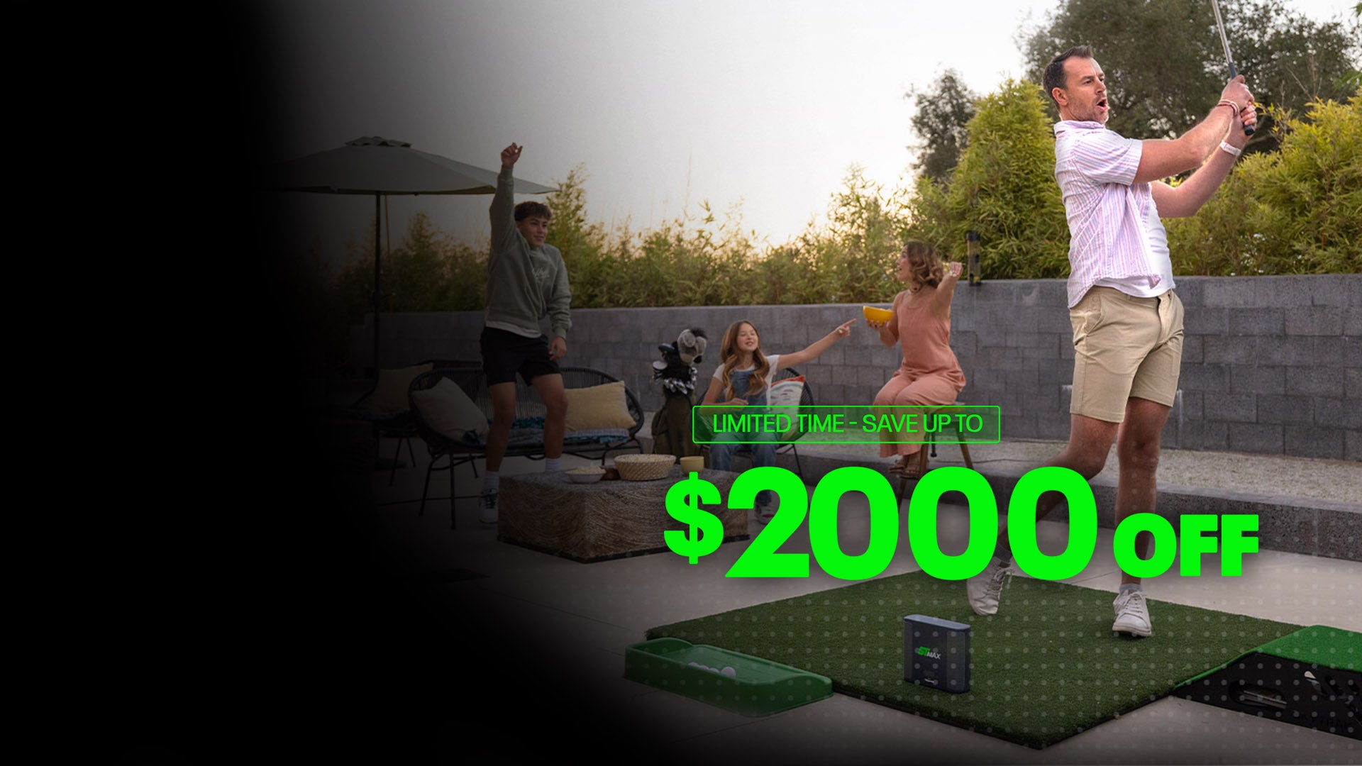 A family cheering for a golfer using a SKYTRAK home simulator on an outdoor patio, part of our Father's Day sale with savings up to $2,000 off ST MAX systems.