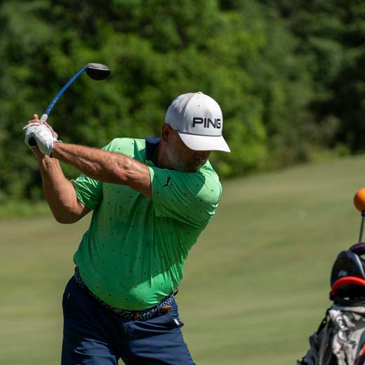 Man hitting golf shot working on improvement