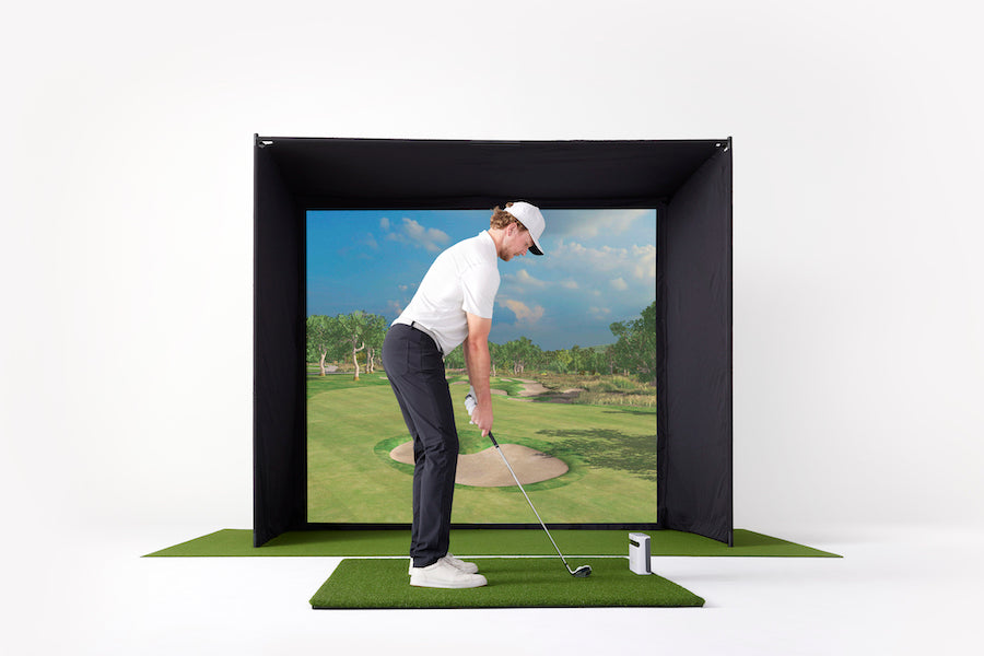 Man hitting on SkyTrak Golf Simulator Studio with the SkyTrak Plus launch monitor