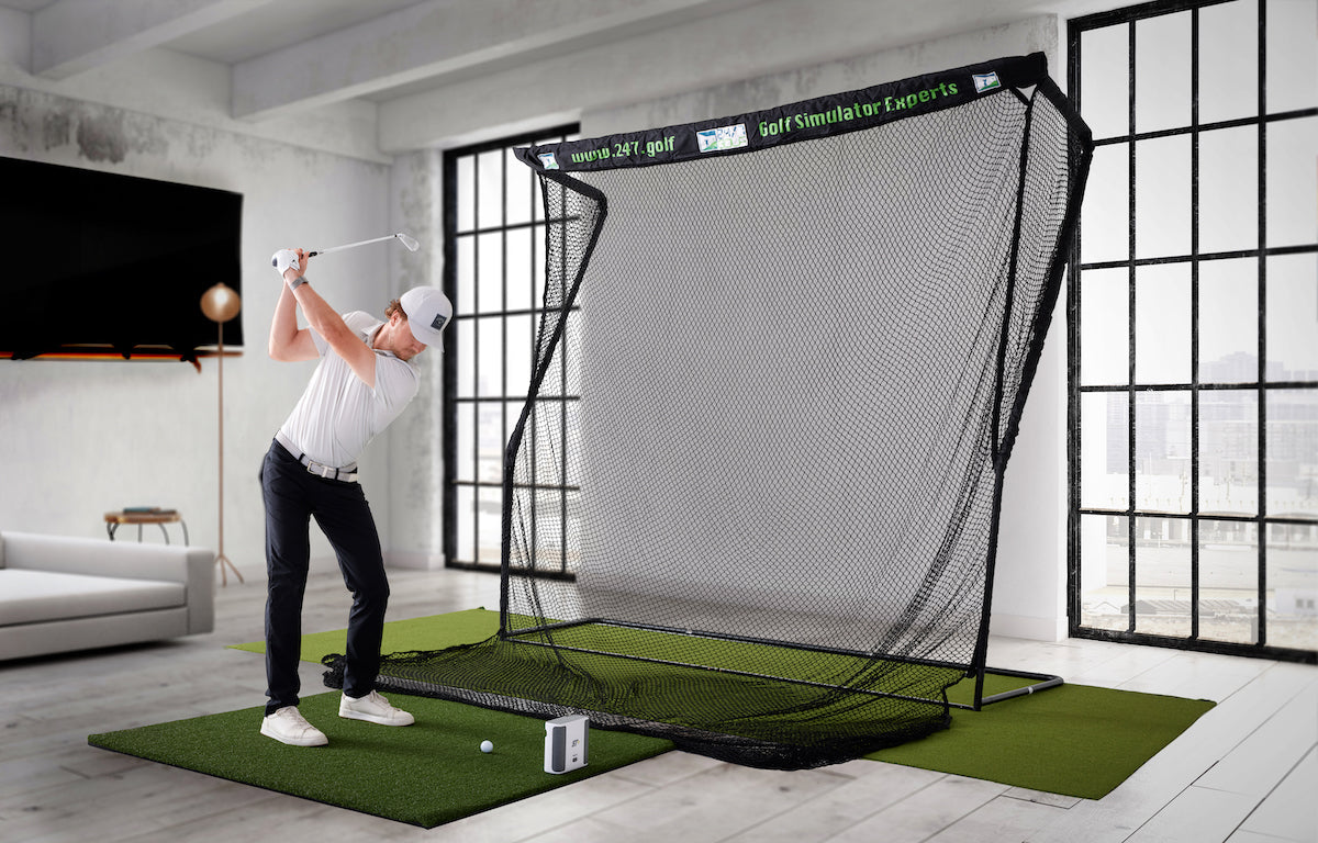 Man hitting balls on the SkyTrak+ simulator studio practice setup