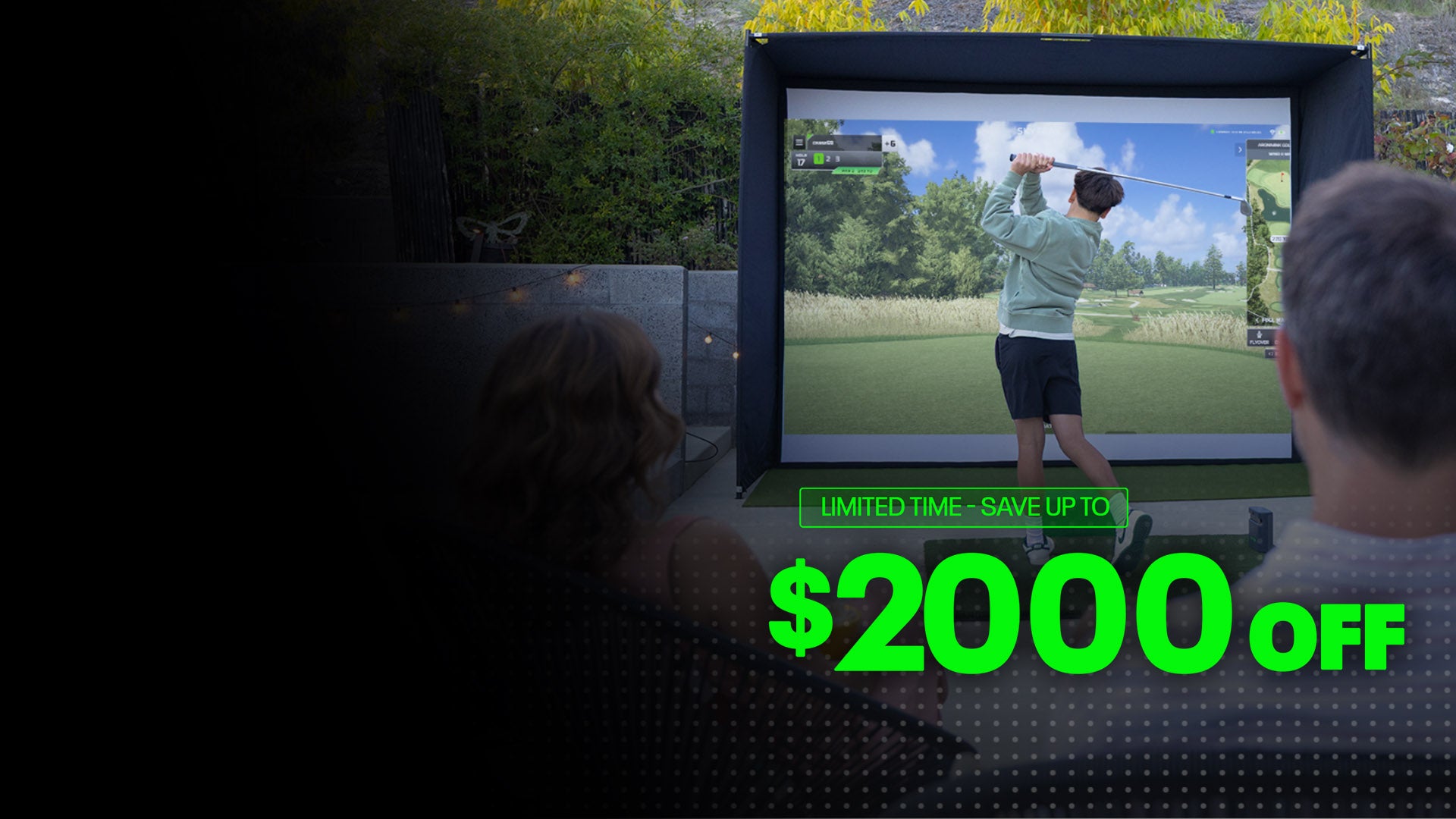 Person hitting a golf ball into a SkyTrak simulator screen during a Father's Day sale event, showcasing home golf practice.